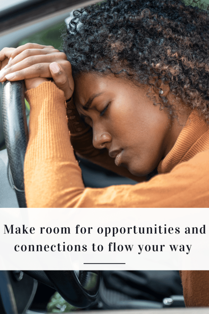 Woman at steering wheel looking tired and frustrated.